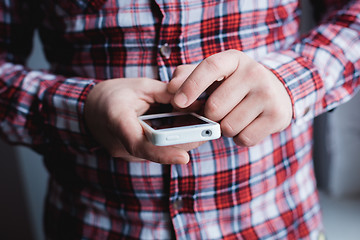 Image showing The man is using a smartphone. Modern mobile phone in hand.