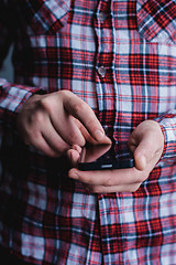 Image showing The man is using a smartphone. Modern mobile phone in hand.