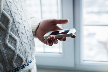 Image showing The man is using a smartphone. Modern mobile phone in hand.