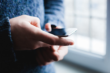 Image showing The man is using a smartphone. Modern mobile phone in hand.