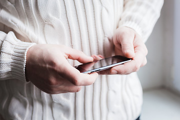 Image showing The man is using a smartphone. Modern mobile phone in hand.