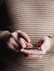 Image showing The man is using a smartphone. Modern mobile phone in hand.