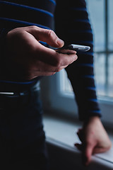 Image showing The man is using a smartphone. Modern mobile phone in hand.