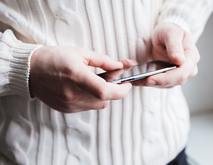 Image showing The man is using a smartphone. Modern mobile phone in hand.