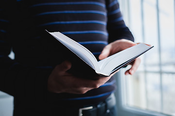 Image showing Man reading. Book in his hands.