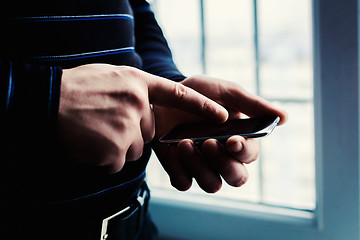 Image showing The man is using a smartphone. Modern mobile phone in hand.