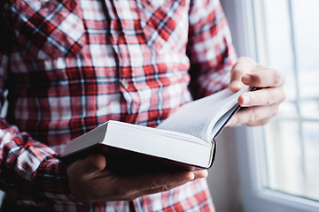 Image showing Man reading. Book in his hands.