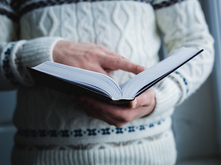 Image showing Man reading. Book in his hands.