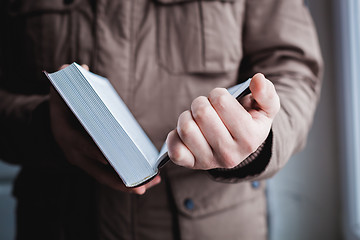 Image showing Man reading. Book in his hands.