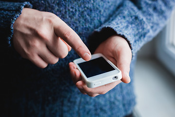 Image showing The man is using a smartphone. Modern mobile phone in hand.