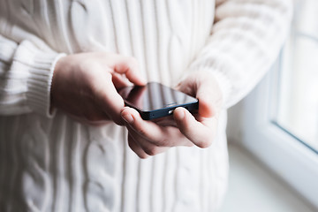 Image showing The man is using a smartphone. Modern mobile phone in hand.