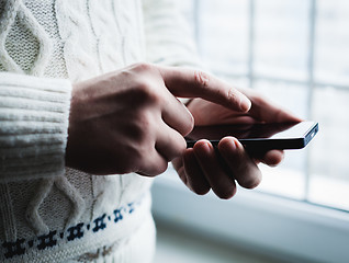 Image showing The man is using a smartphone. Modern mobile phone in hand.