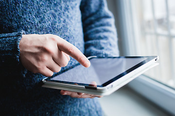 Image showing The man uses a tablet PC. Modern gadget in hand.