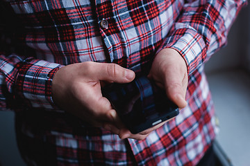 Image showing The man is using a smartphone. Modern mobile phone in hand.