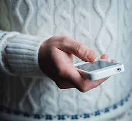 Image showing The man is using a smartphone. Modern mobile phone in hand.