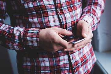 Image showing The man is using a smartphone. Modern mobile phone in hand.