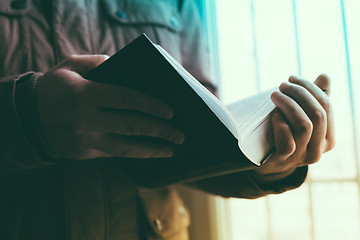 Image showing Man reading. Book in his hands.