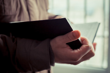 Image showing Man reading. Book in his hands.