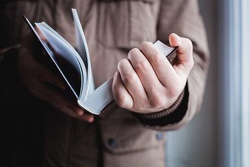 Image showing Man reading. Book in his hands.