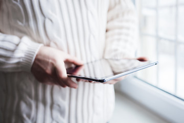 Image showing The man uses a tablet PC. Modern gadget in hand.