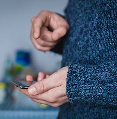 Image showing The man is using a smartphone. Modern mobile phone in hand.