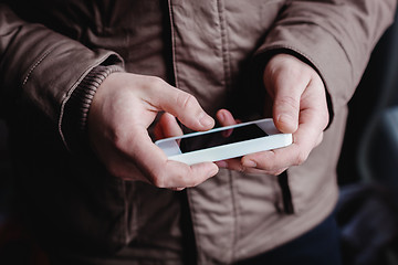 Image showing The man is using a smartphone. Modern mobile phone in hand.