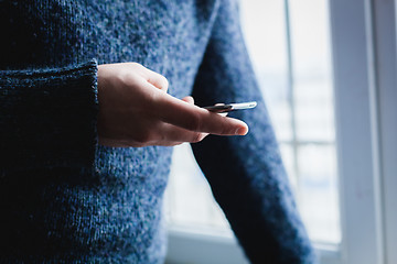 Image showing The man is using a smartphone. Modern mobile phone in hand.