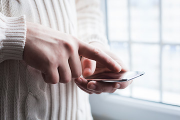 Image showing The man is using a smartphone. Modern mobile phone in hand.