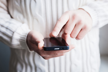 Image showing The man is using a smartphone. Modern mobile phone in hand.