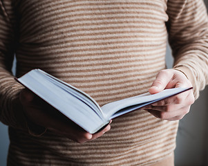 Image showing Man reading. Book in his hands.