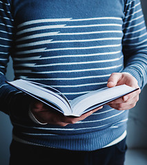 Image showing Man reading. Book in his hands.