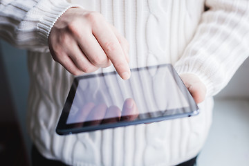 Image showing The man uses a tablet PC. Modern gadget in hand.