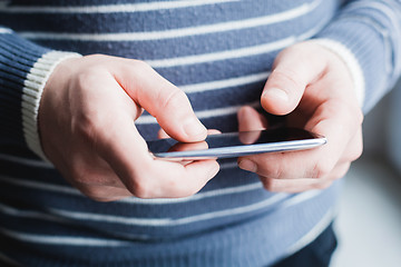 Image showing The man is using a smartphone. Modern mobile phone in hand.