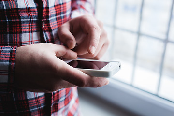 Image showing The man is using a smartphone. Modern mobile phone in hand.