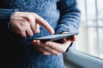 Image showing The man uses a tablet PC. Modern gadget in hand.