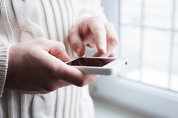 Image showing The man is using a smartphone. Modern mobile phone in hand.