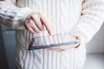 Image showing The man uses a tablet PC. Modern gadget in hand.