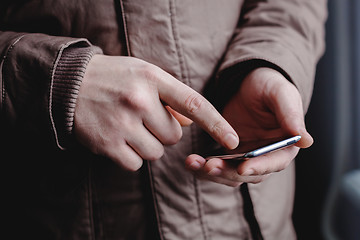 Image showing The man is using a smartphone. Modern mobile phone in hand.