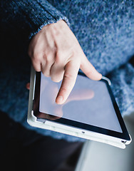 Image showing The man uses a tablet PC. Modern gadget in hand.