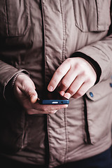 Image showing The man is using a smartphone. Modern mobile phone in hand.