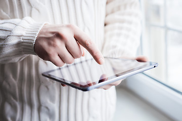 Image showing The man uses a tablet PC. Modern gadget in hand.