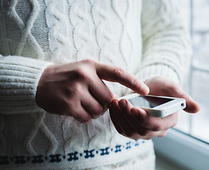 Image showing The man is using a smartphone. Modern mobile phone in hand.