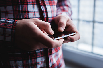 Image showing The man is using a smartphone. Modern mobile phone in hand.