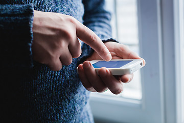 Image showing The man is using a smartphone. Modern mobile phone in hand.