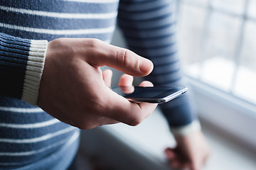 Image showing The man is using a smartphone. Modern mobile phone in hand.