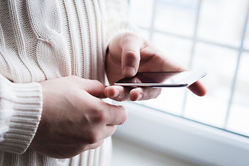 Image showing The man is using a smartphone. Modern mobile phone in hand.