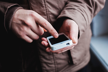 Image showing The man is using a smartphone. Modern mobile phone in hand.