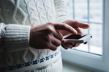 Image showing The man is using a smartphone. Modern mobile phone in hand.