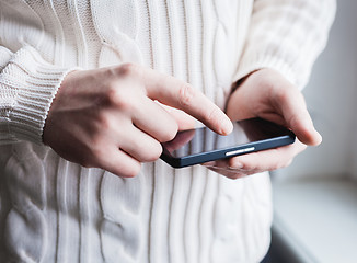 Image showing The man is using a smartphone. Modern mobile phone in hand.