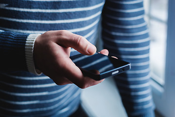 Image showing The man is using a smartphone. Modern mobile phone in hand.